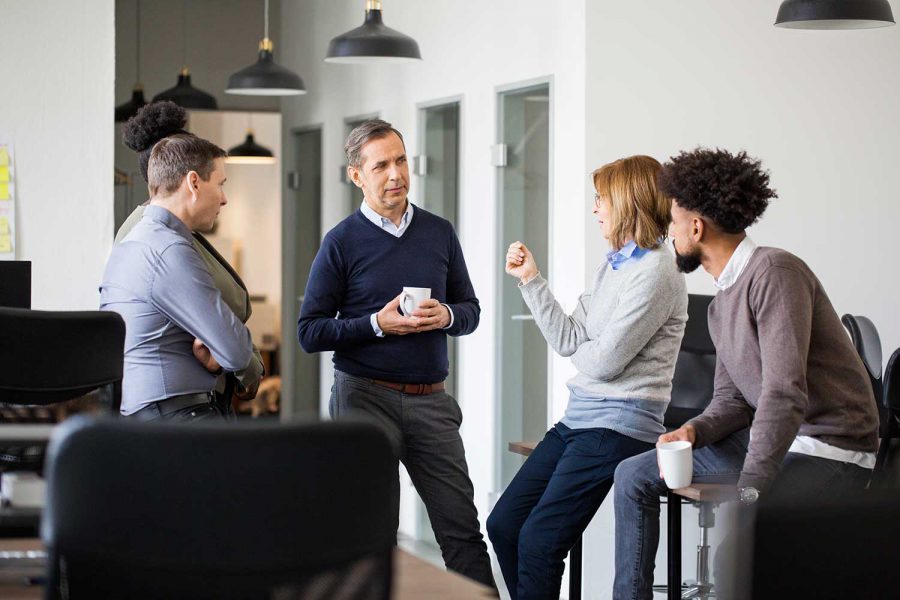 four people havign a discussion at work